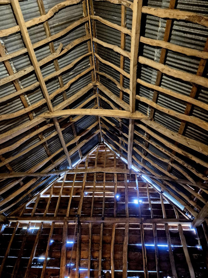 Inside the big barn at Flint Hall — the timber roof structure